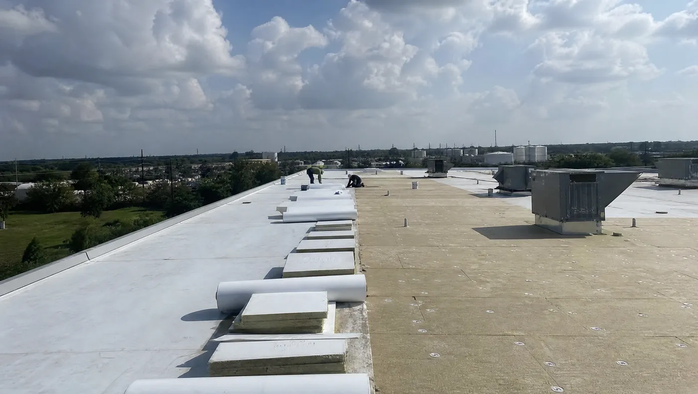 Commercial roofing crew working on a warehouse roof off Highway 288 in Brazoria County