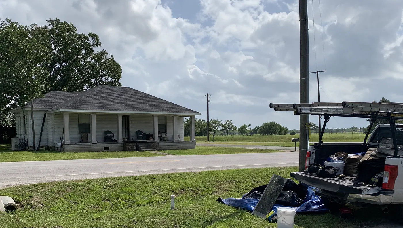 Roofers replacing a shingle roof on a home in Arcola Texas off FM 521